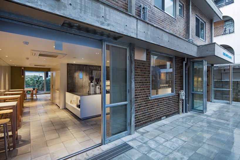 blue bottle coffee cafe by schemata architects mediates between its building and the city