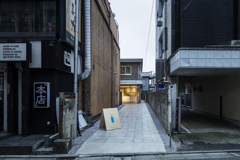 blue bottle coffee cafe by schemata architects mediates between its building and the city