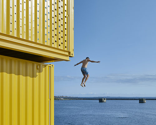 sweco architects' water sports center in denmark is built using recycled containers