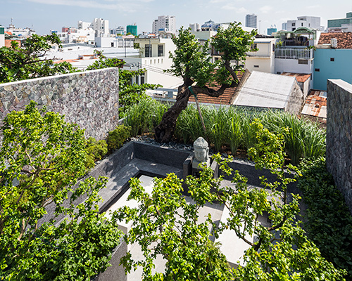 MW archstudio's tree-filled house in vietnam is topped with a secluded roof garden