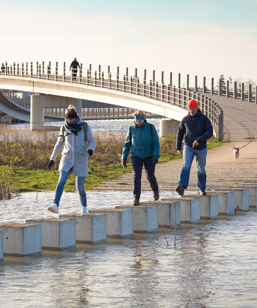 NEXT architects uses stepping stones to connect zalige bridge during flooding