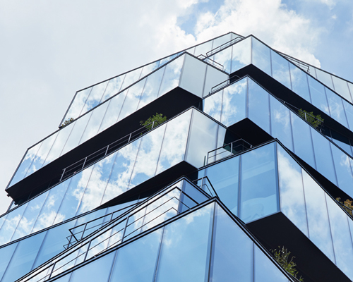 ETHNOS maximizes rental space in its fully glazed over-stacked building in tokyo