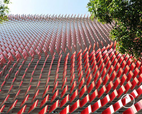 a 3D facade of 7,553 tiles wraps KIA's experience centre with algorithmic patterns