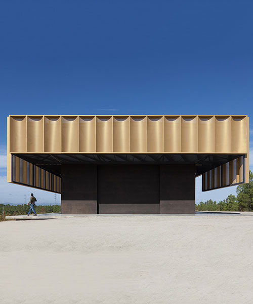 atelier rua wraps a winery pavilion in golden colored metal skin in portugal