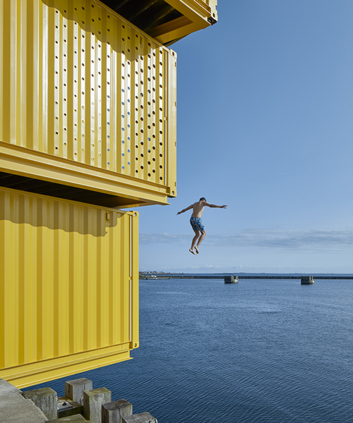 sweco architects' water sports center in denmark is built using recycled containers