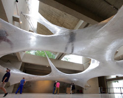 numen/for use create massive parasitic-like tape sculpture for you to explore
