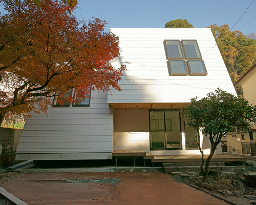 yuji tanabe's LL house in japan is slanted to capture views above the nearby mountains