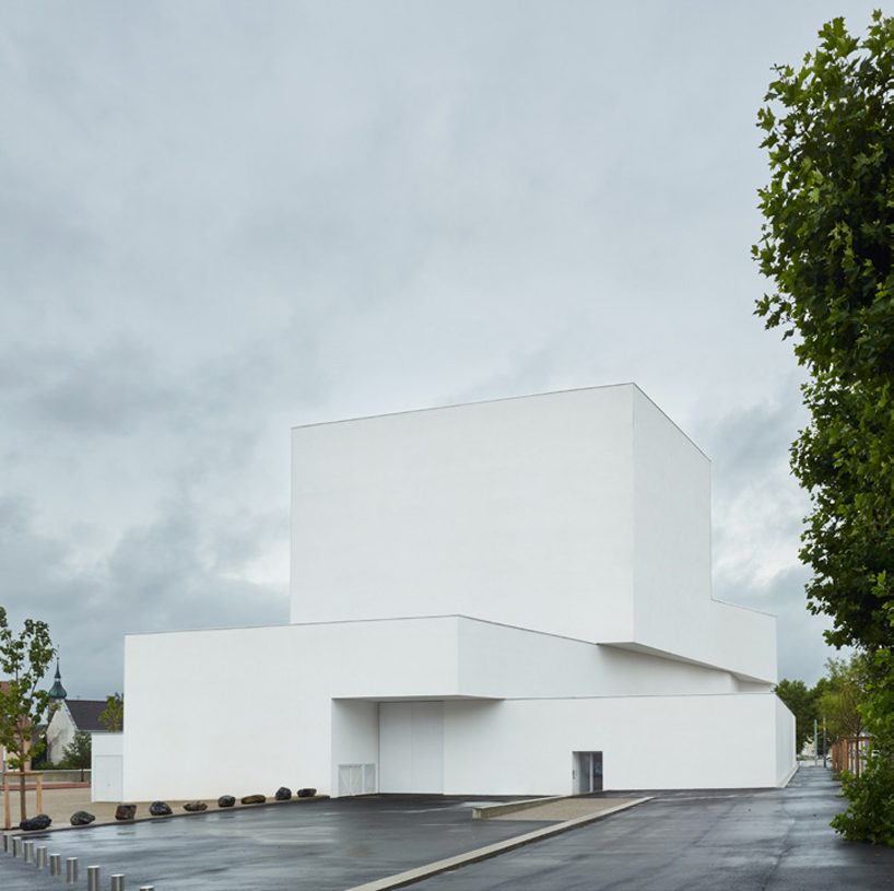 dominique coulon's white volume-stacked theater in france becomes a symbol of the city