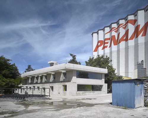 architektura blends raw, concrete structure with its industrial surroundings