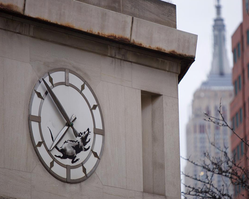 banksy tags major manhattan cross street with a rat in a scurry