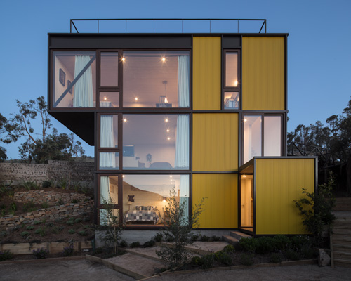this geometric yellow house fits into the chilean landscape like a tetris piece