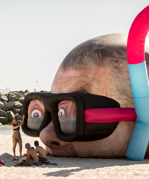 inflated damien hirst head pops up on perth beach, snorkeling for another $12 million shark