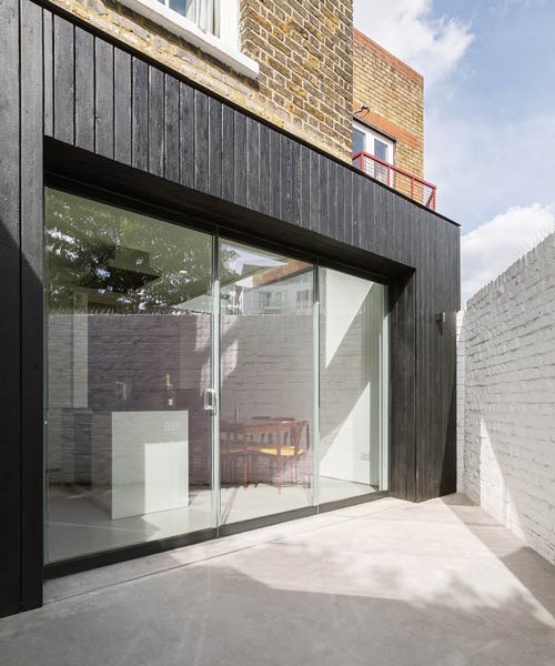 dickson architects extends a victorian house with black timber box in london