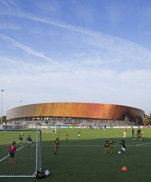 faulknerbrowns' copper-enveloped sports campus in the hague embodies principle of motion
