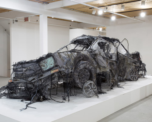 this full-scale demolished car is constructed from ghost-like textiles by jannick deslauriers