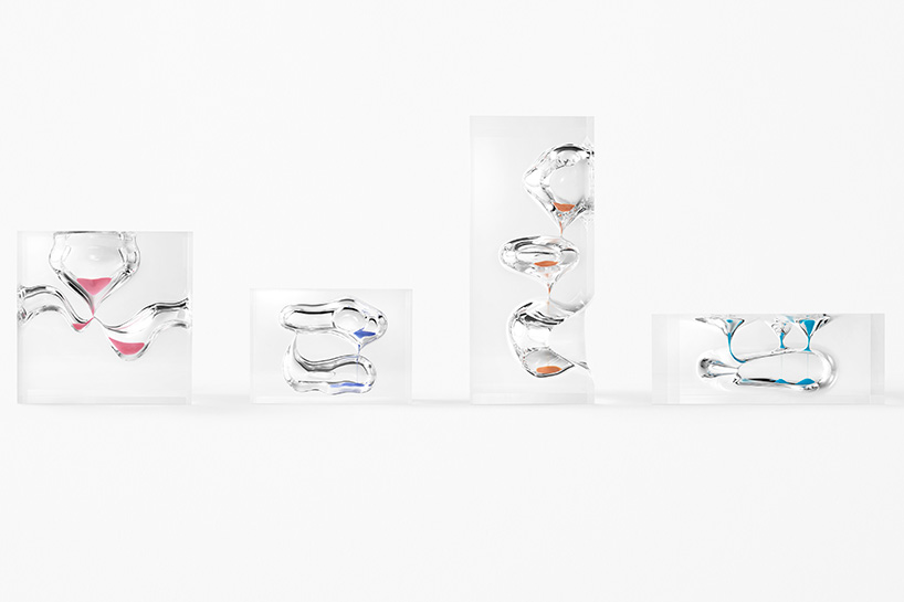 nendo redesigns the sands of time with four organic, riverlike hourglasses