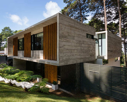 paz arquitectura's exposed concrete house in guatemala contrasts with surrounding woods