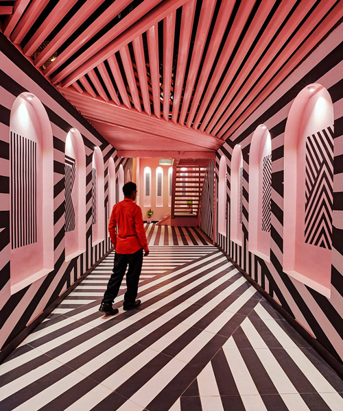 this restaurant in india combines pink interiors with bold zebra stripes