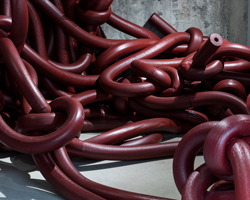 artist weaves labyrinth of deep red knots through clinic-turned-art-gallery in japan