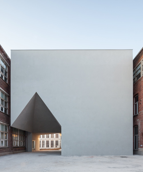 all-white building by aires mateus unites architecture school in belgium