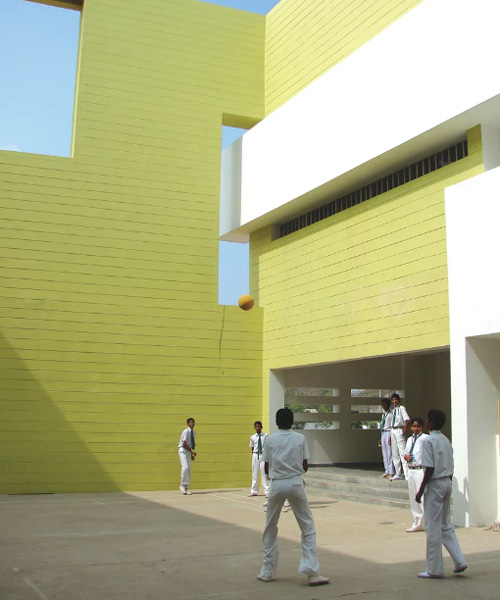 NUDES builds high school as monolithic mass 'punctuated' by voids in india