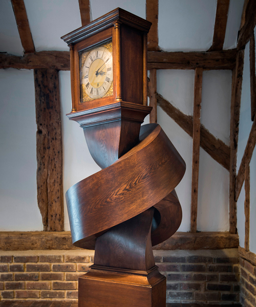 alex chinneck ties antique grandfather clock in a knot of ticks and tocks