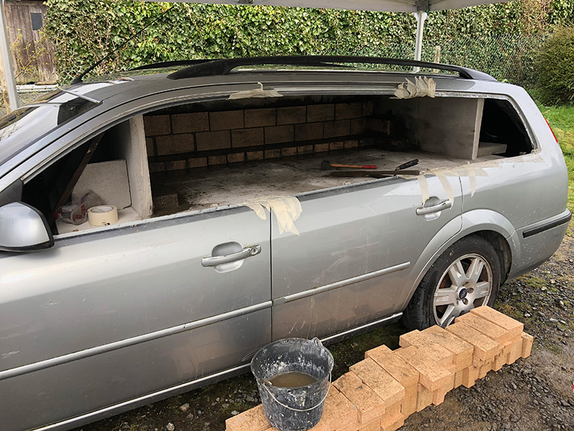this old car was turned into a wood-burning pizza oven