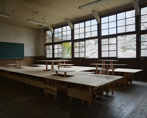 wooden platform by td-atelier turns old classroom into multipurpose space
