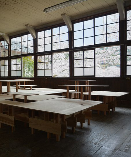 wooden platform by td-atelier turns old classroom into multipurpose space