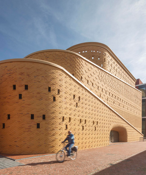 eastern hues and patterns adorn the brick facade of this car park by dok architects