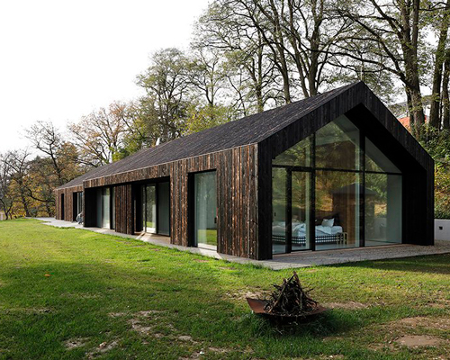 one-story family house in czech republic by ateliér kunc is covered with charred larch