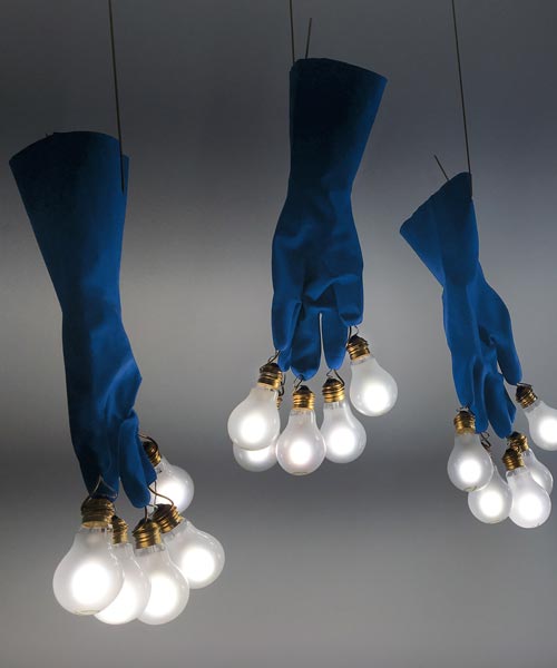 ingo maurer's luzy lights illuminate the fingertips of plastic gloves