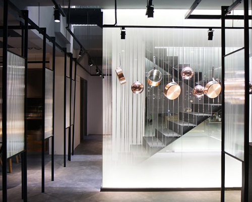 kitchen L by XU studio is a flexible shanghai restaurant decorated with copper kitchenware