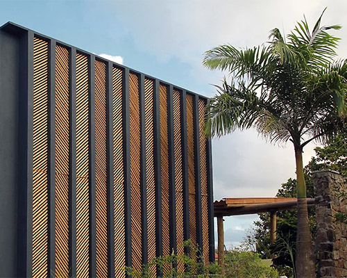 vilela florez arranges bamboo in a herringbone pattern for the facade of this brazilian residence