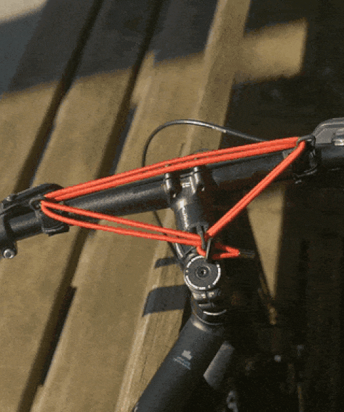 the world's smallest bicycle rack is an elastic strap that carries even the bulkiest of items