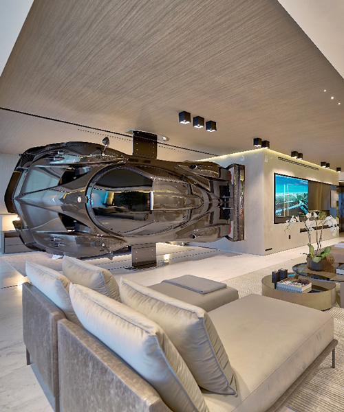 this miami residence is outfitted with a $1.5 million supercar mounted on the wall