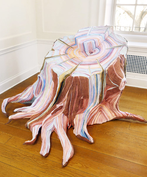 artist uses discarded and disused fabric to create intricately layered tree stumps