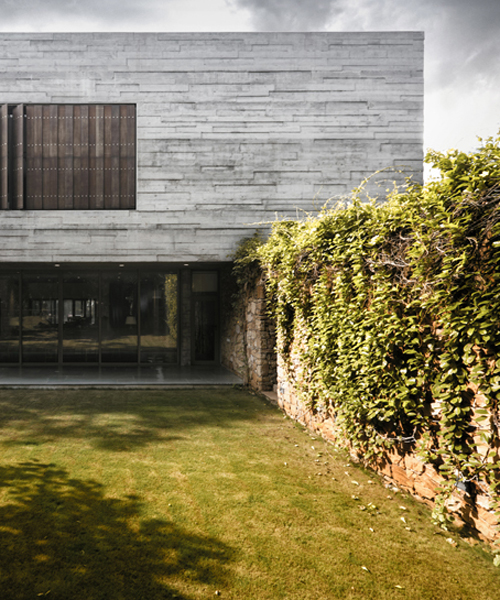 FLXBL blends exposed concrete with greenery for this private residence in india