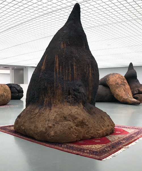 gelitin invites visitors to walk around giant turds in latest exhibition 'vorm - fellows - attitude'