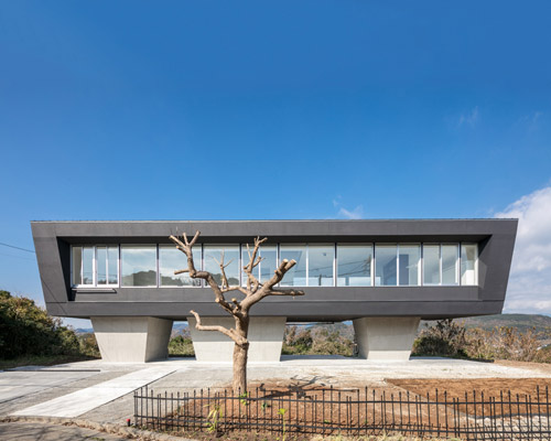 hiraoka architects sets a house on concrete legs on a hilltop in suzaki