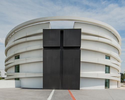 hugo correia encircles white concrete church in northern portugal with elliptical rings