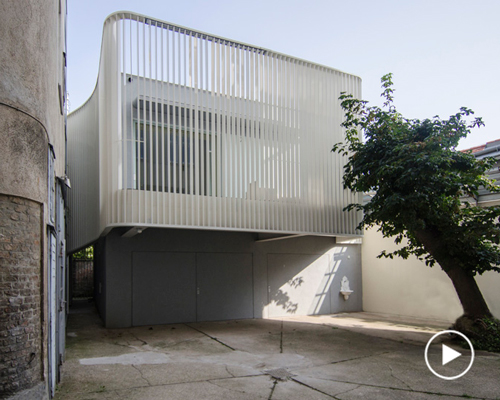 smartvoll renovates viennese house enclosed by 'an elegant dress of fins'
