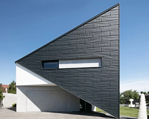 reform architekt's triangular house in poland perfectly fits surrounding environment