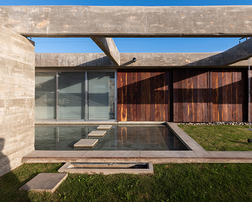 casa CG by adolfo mondejar of argentina is a composition of concrete, wood, and water