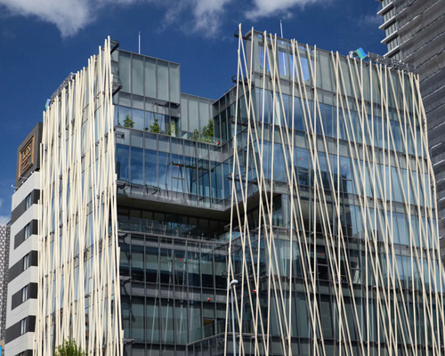 kengo kuma's wooden cladding emulates the effects of a japanese forest