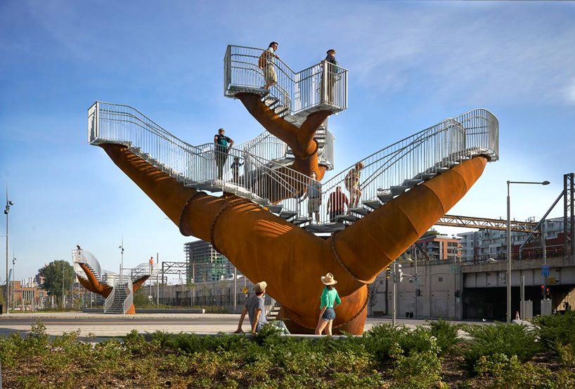 michel de broin's public sculptures emerge from the ground like giant tree trunks