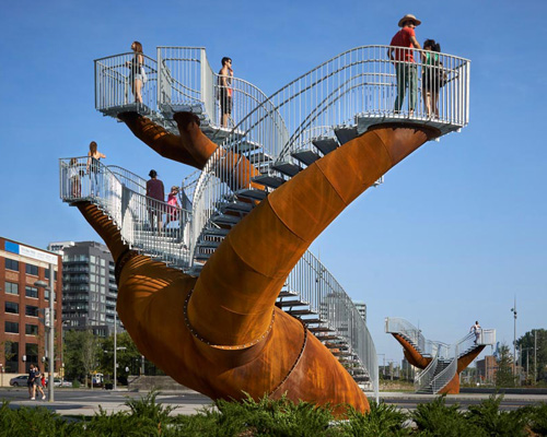 michel de broin's public sculptures emerge from the ground like giant tree trunks