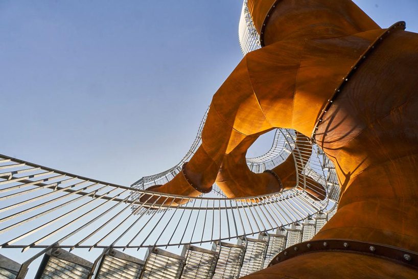 michel de broin's public sculptures emerge from the ground like giant tree trunks