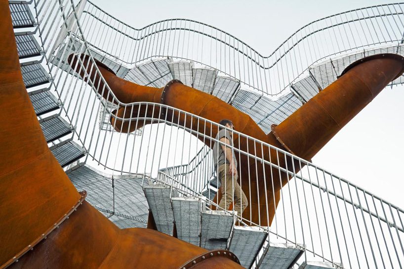 michel de broin's public sculptures emerge from the ground like giant tree trunks