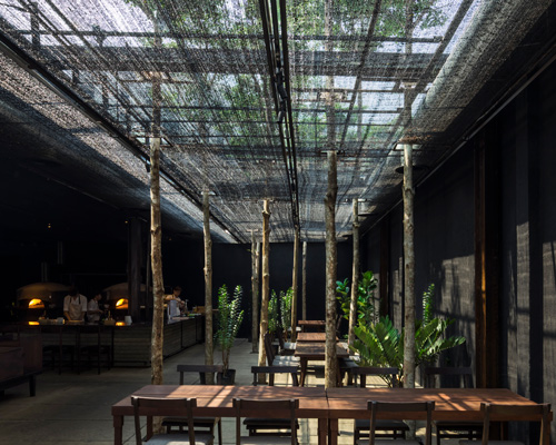 NISHIZAWAARCHITECTS uses agricultural netting to shade diners at vietnam restaurant